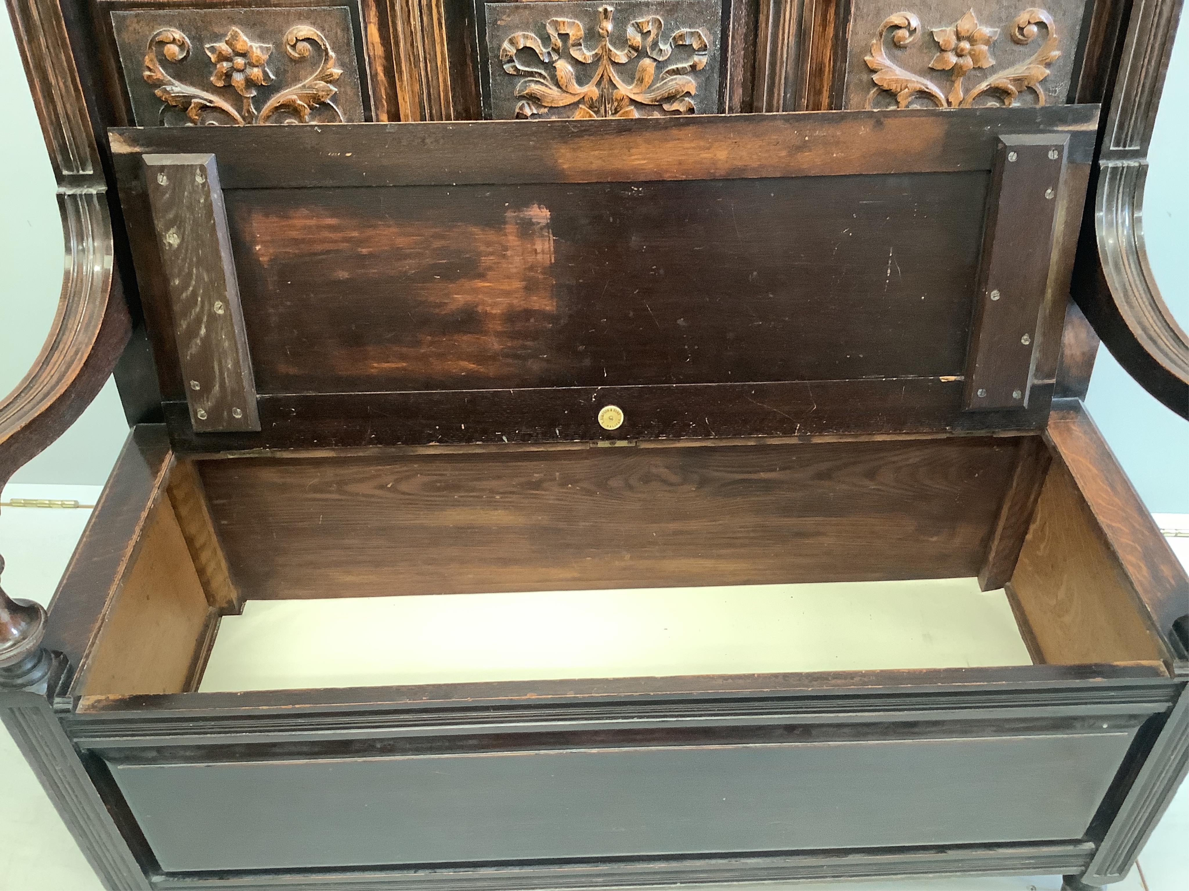 A late Victorian oak box seat settle, width 107cm, depth 44cm, height 109cm. Condition - fair